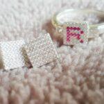Orecchini ed anello con base in argento e zirconi bianchi con lettera con zirconi color "rubi"